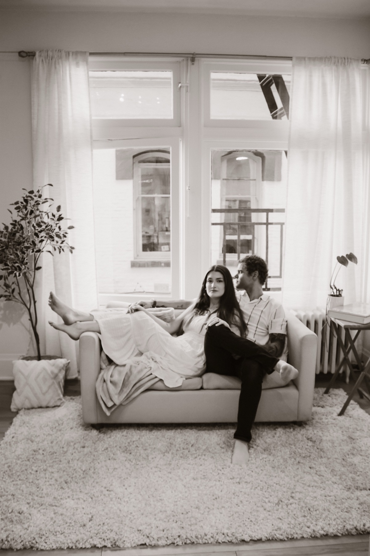 Couple portrait seated on the Studio Rose couch.